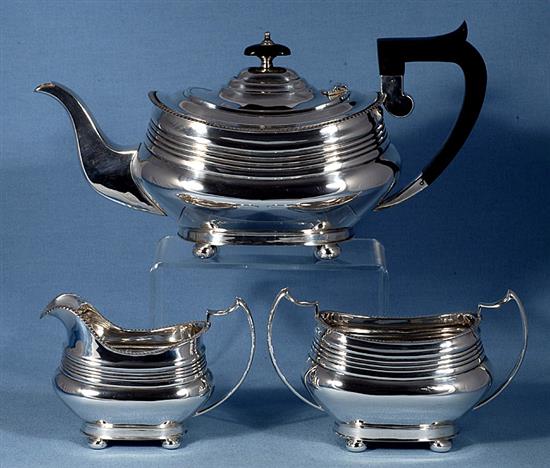 A 1940s silver three piece tea set, by William Bush & Sons, teapot height 156mm, gross weight 41.2oz/1283grms